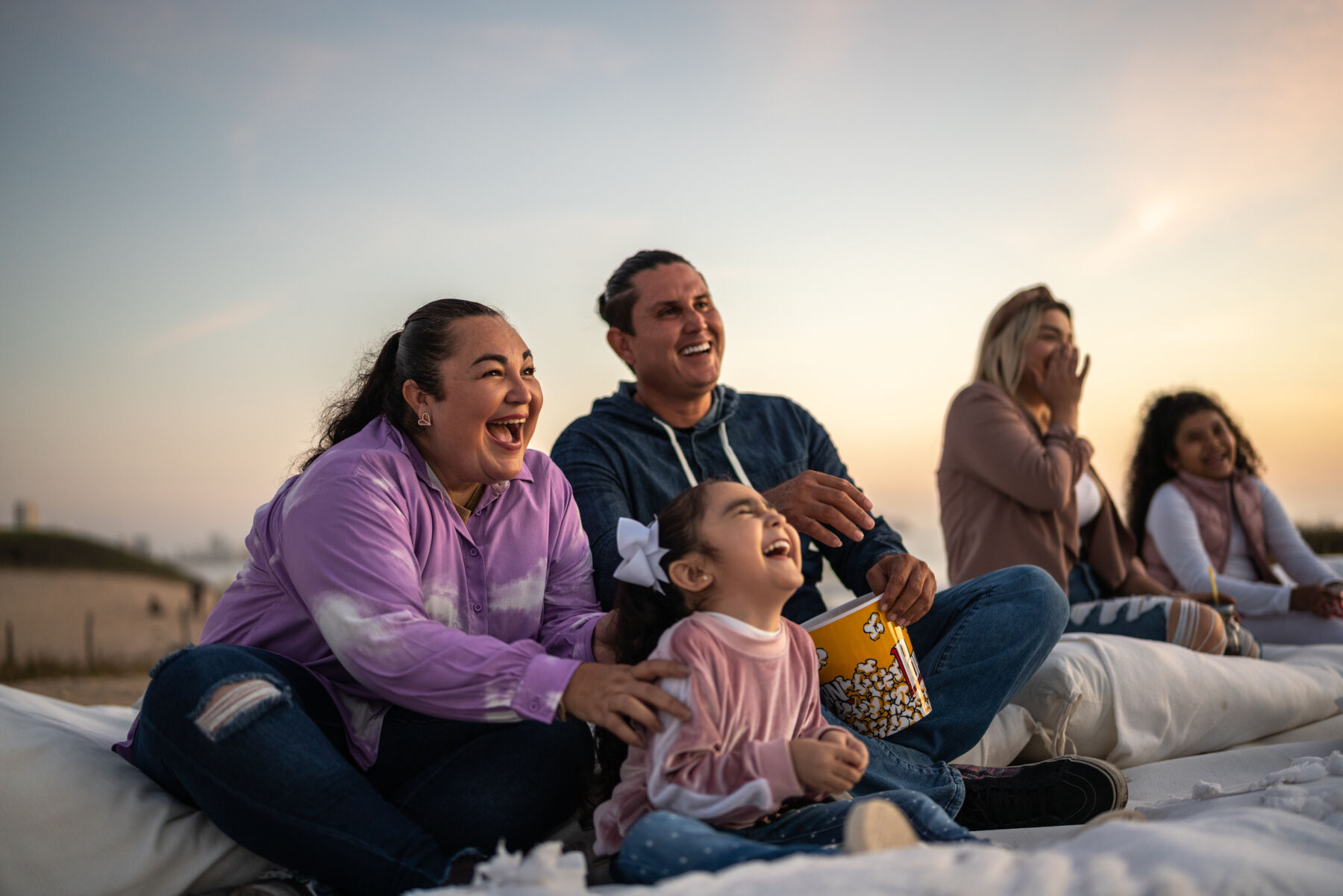 Family watching a movie outdoors