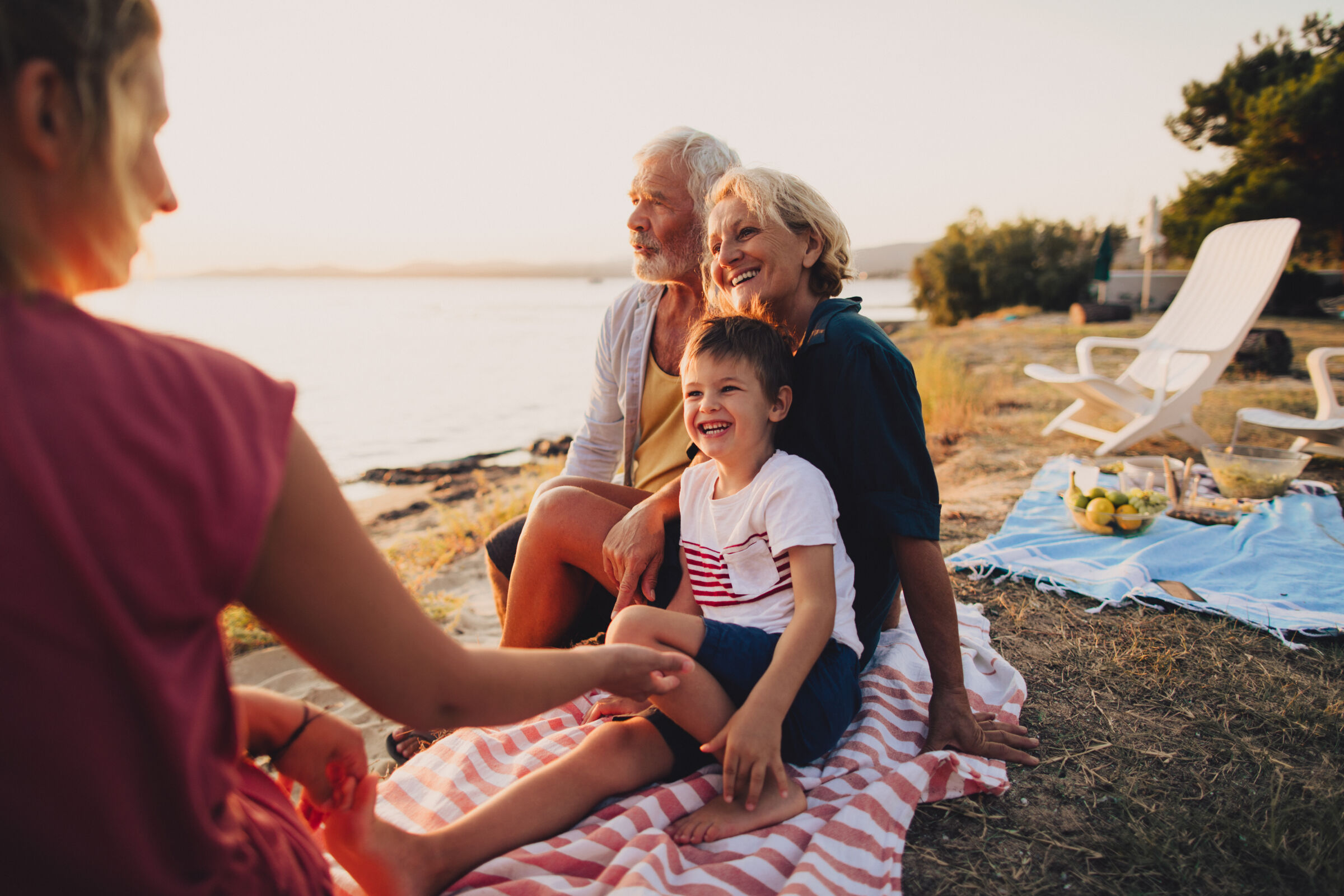 Family relaxing on lakeshore