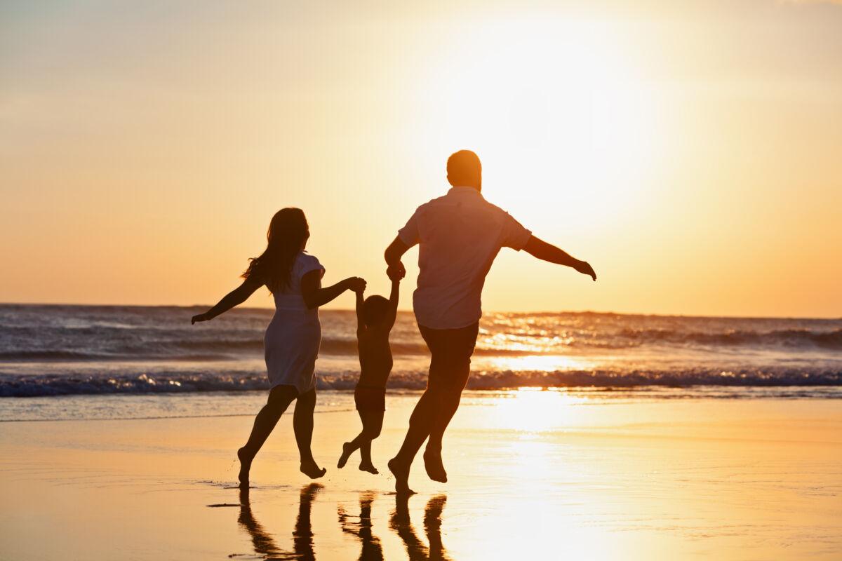 Family on the beach at sunset