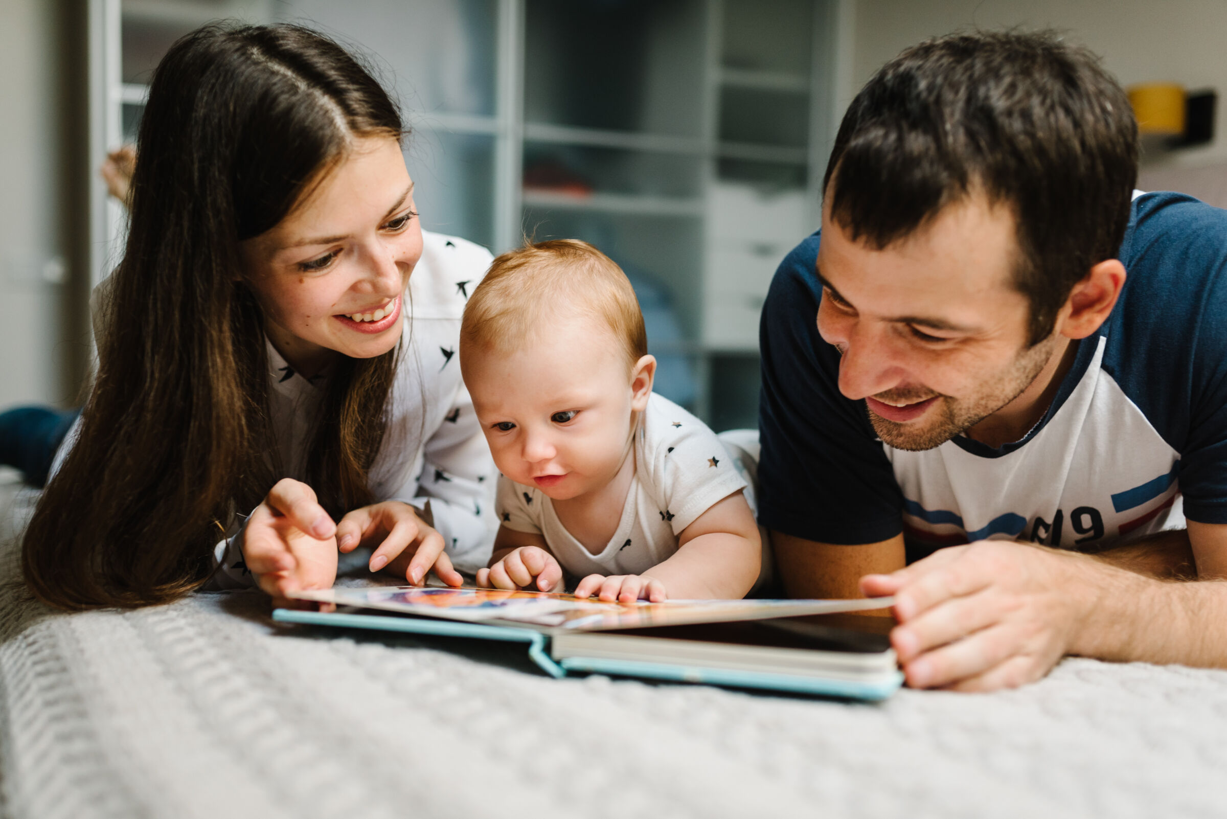 Parents reading to their baby
