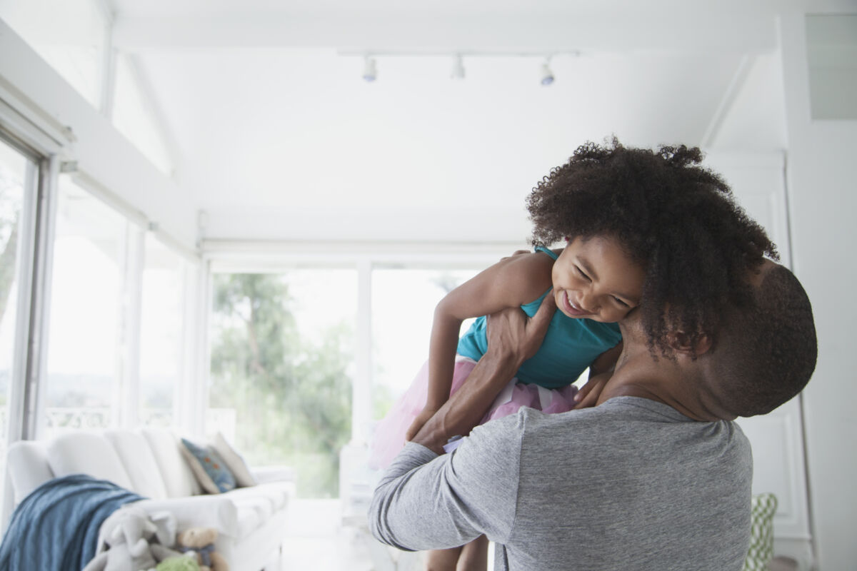 Father and daughter cuddling and playing