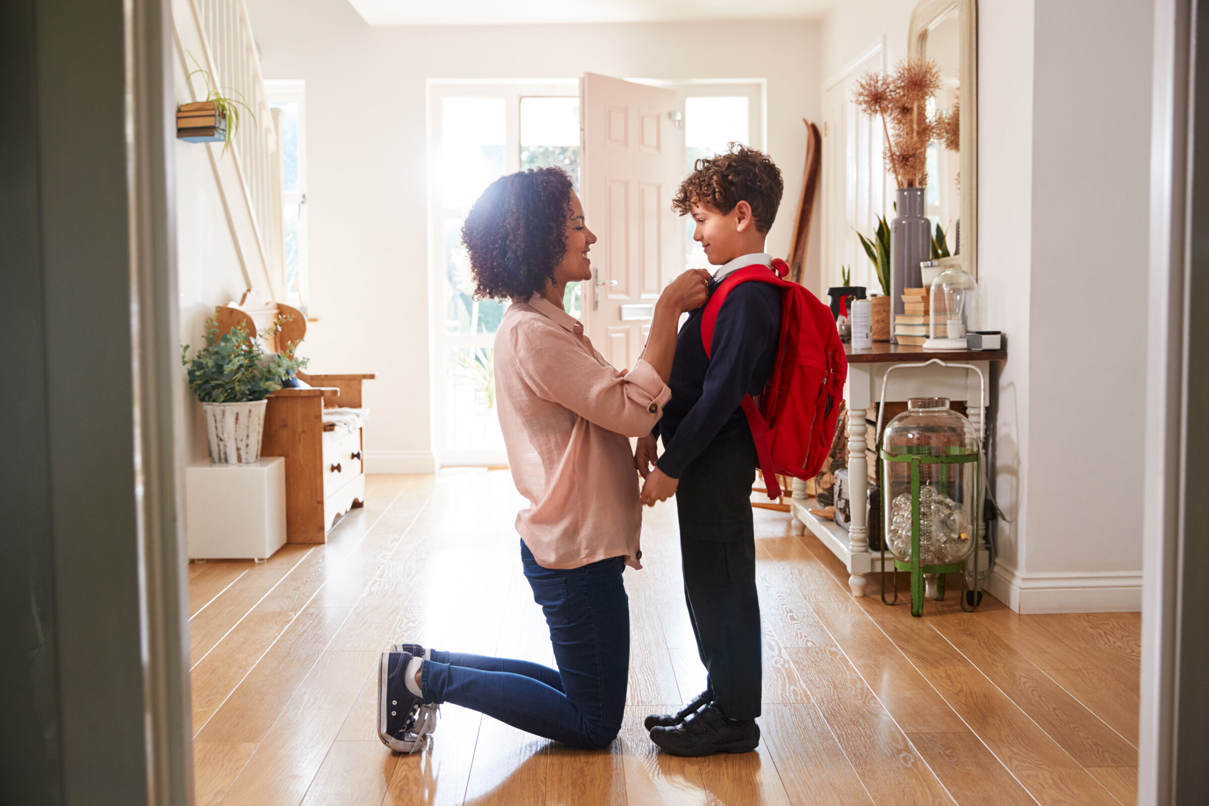Mother helping son get ready for school