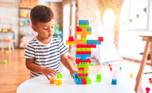 Toddler playing with building blocks