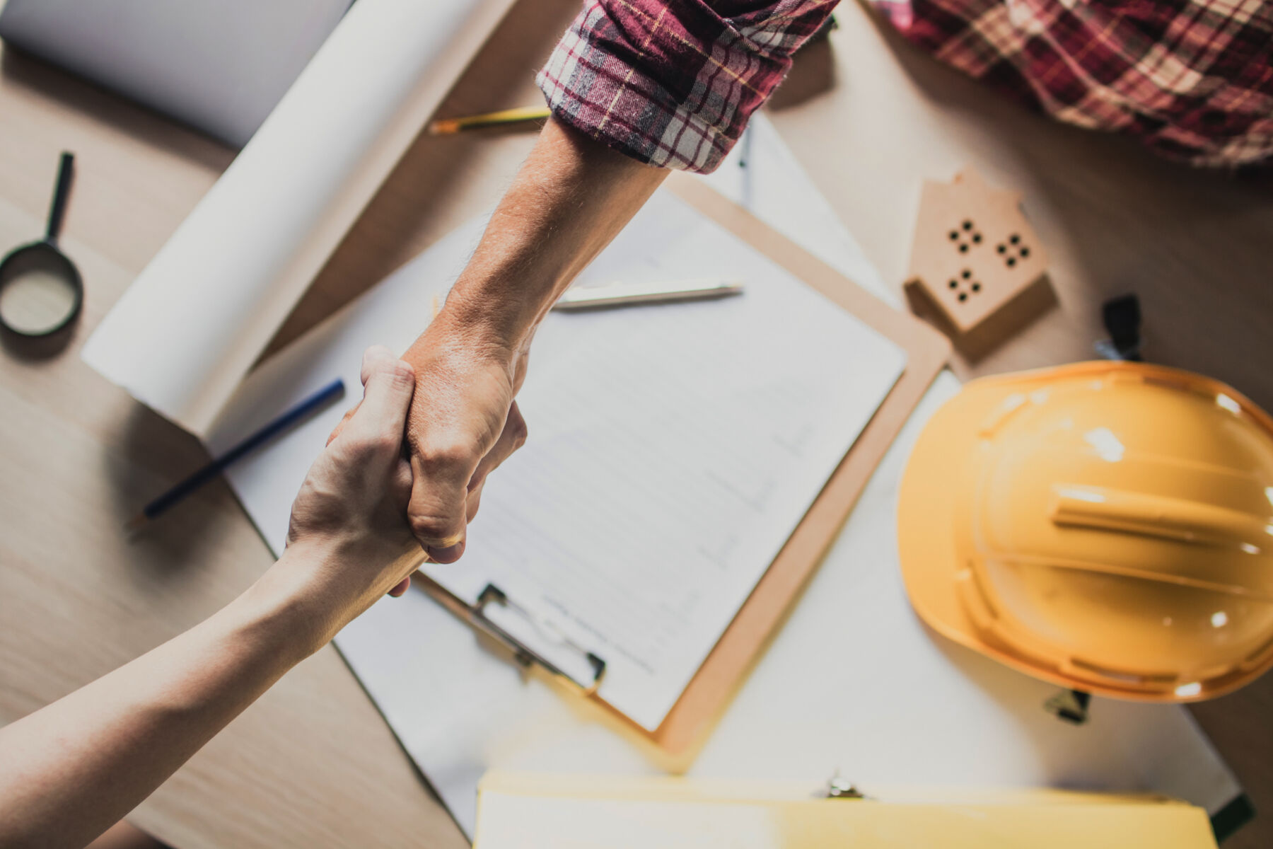 Construction worker handshake with client