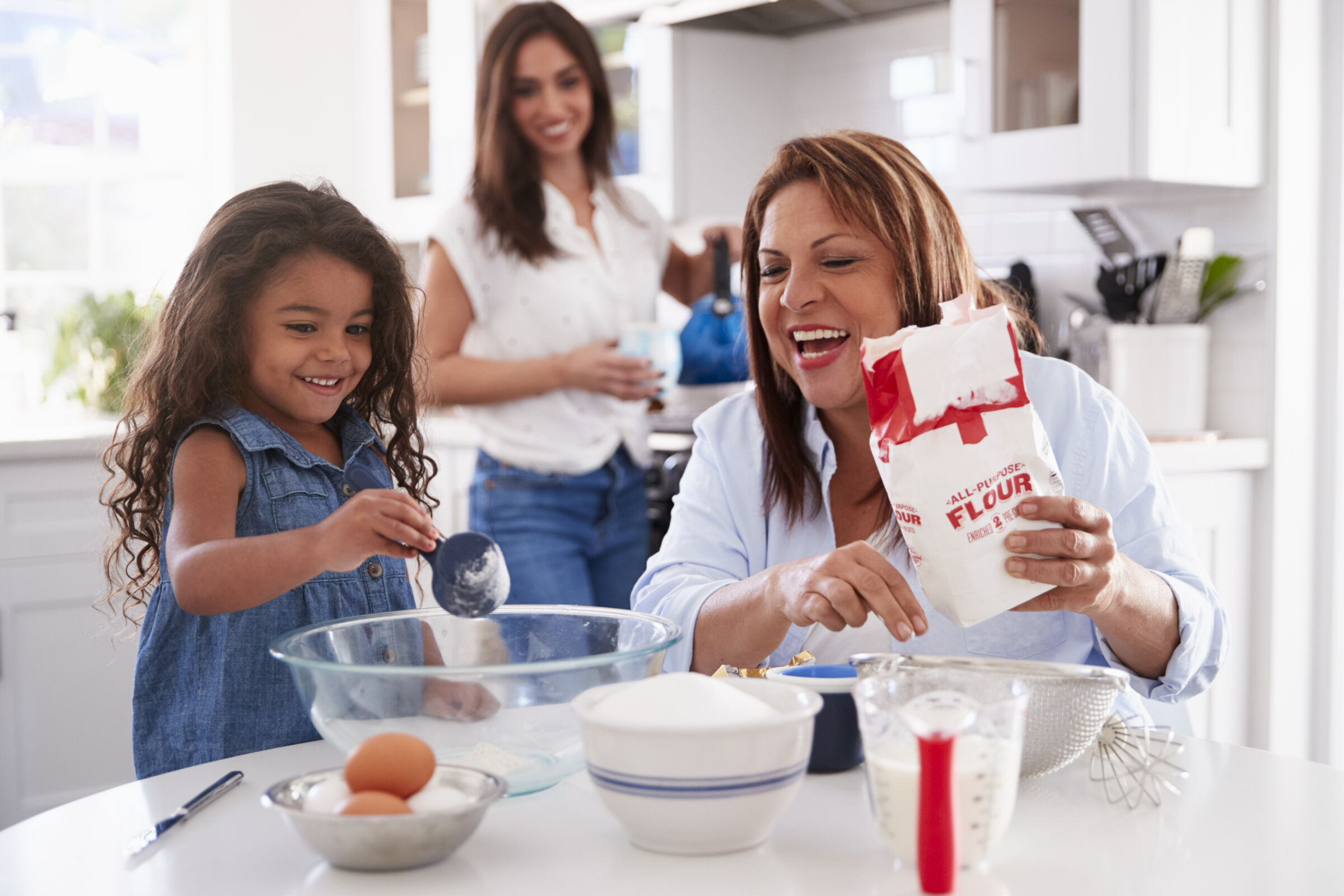 Mom, child, and grandma baking