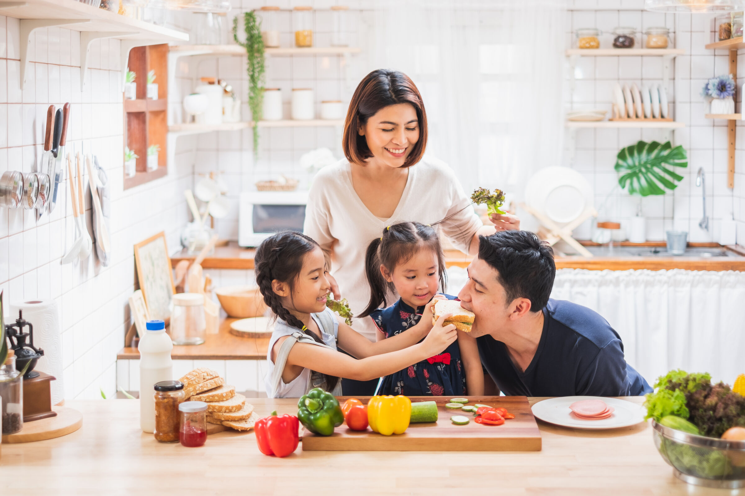 Family making and eating sandwiches