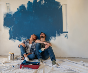 Couple painting a wall