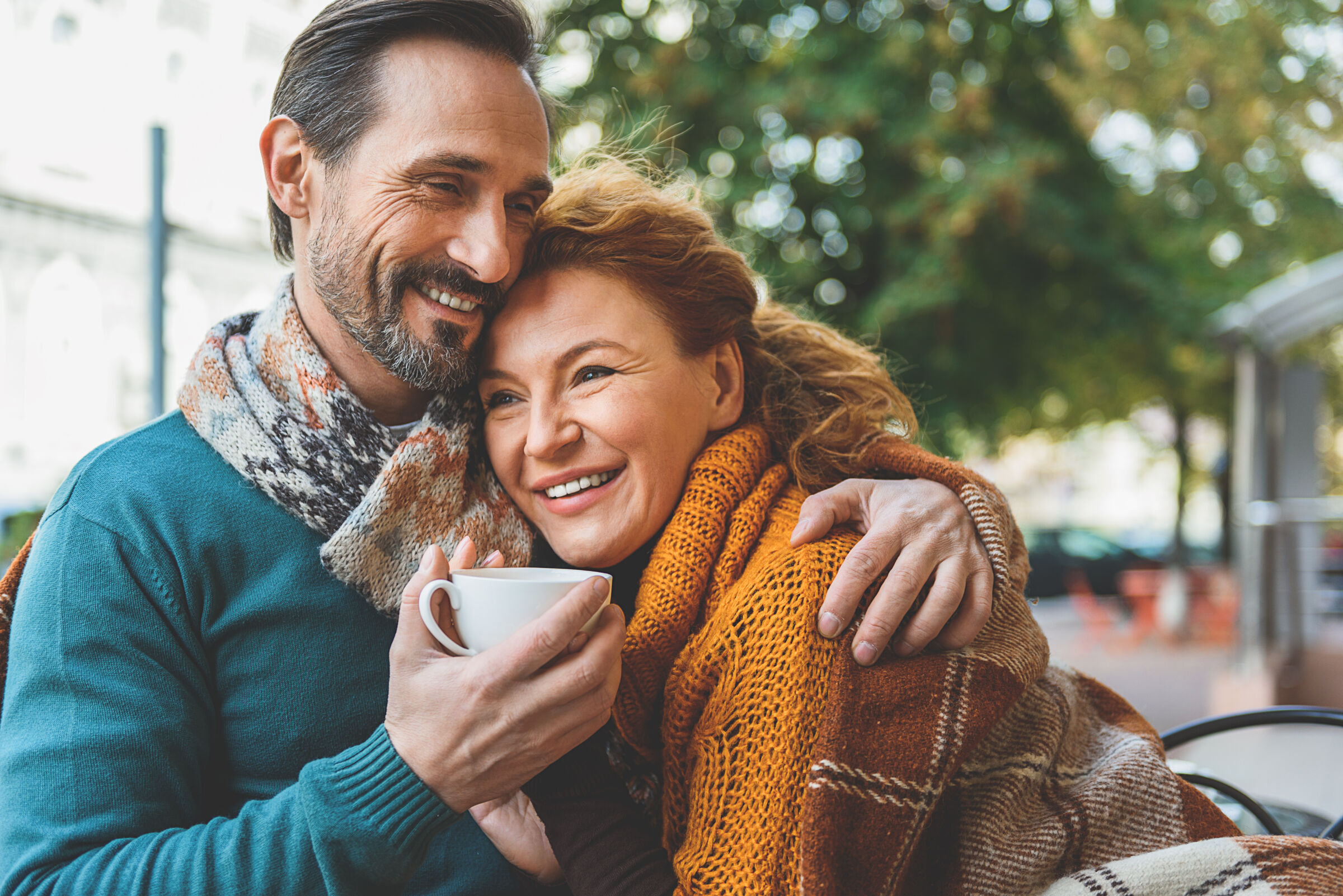 Couple cuddling outside in autumn
