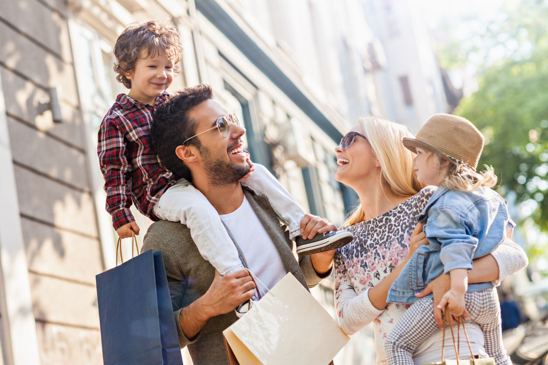 Family with two kids shopping on a sunny day