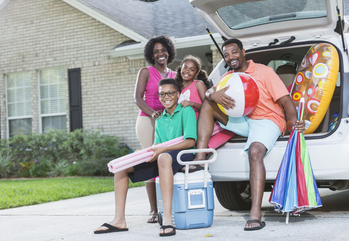 Family posing, packed for vacation