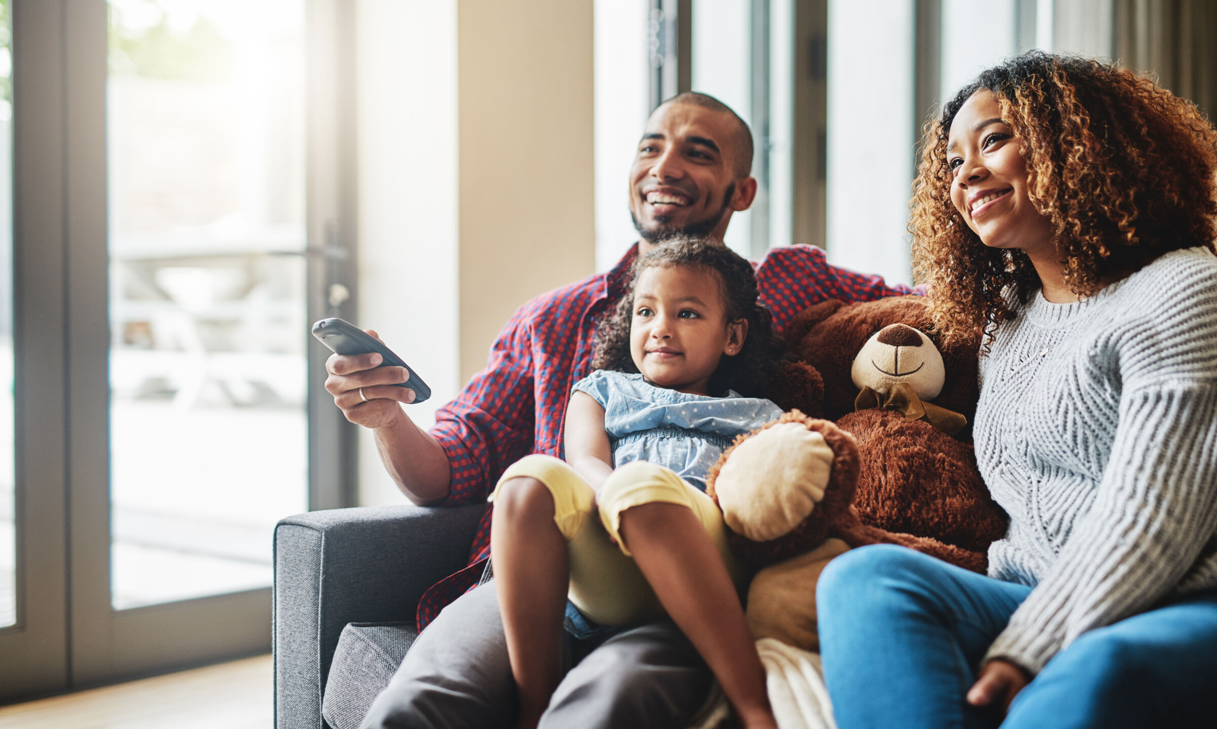 Family watching TV on the couch