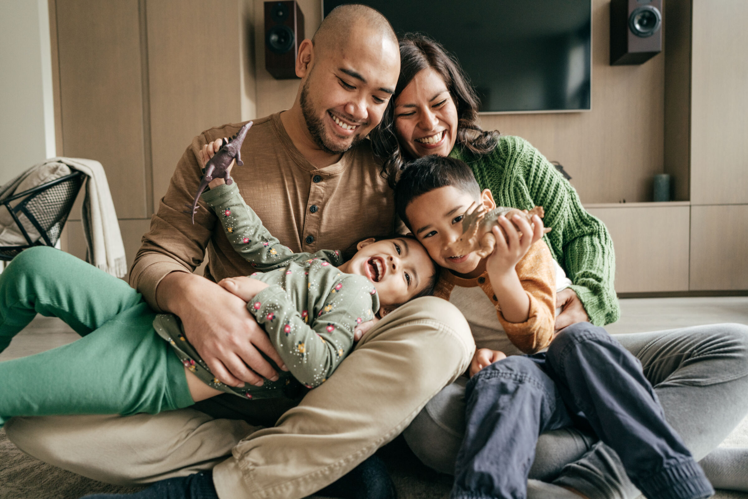 Family cuddling and playing on the floor