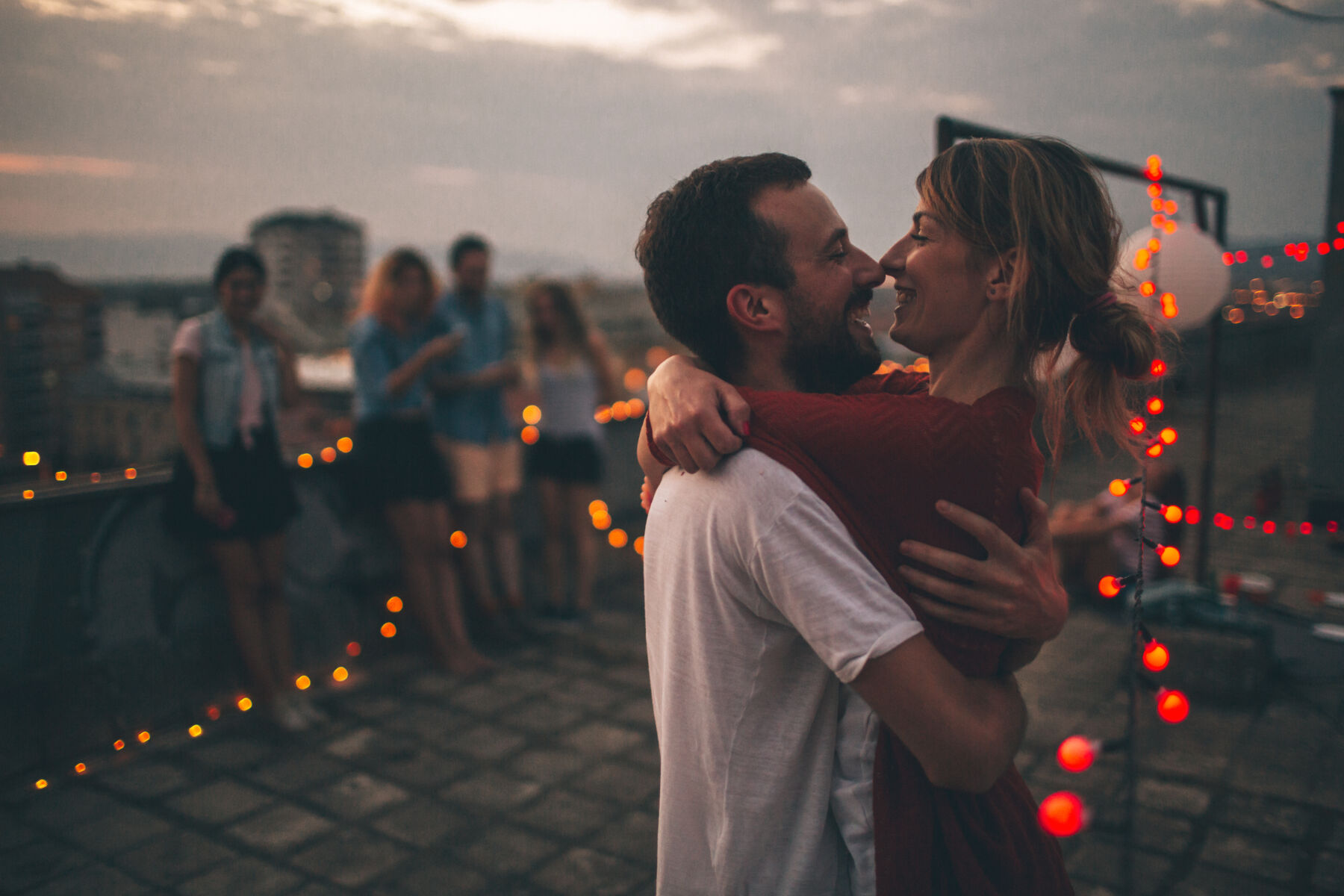 Young couple hugging at dusk