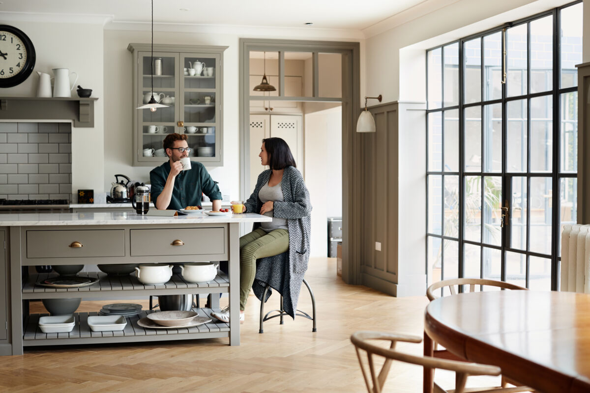 Young couple sitting at the kitchen island