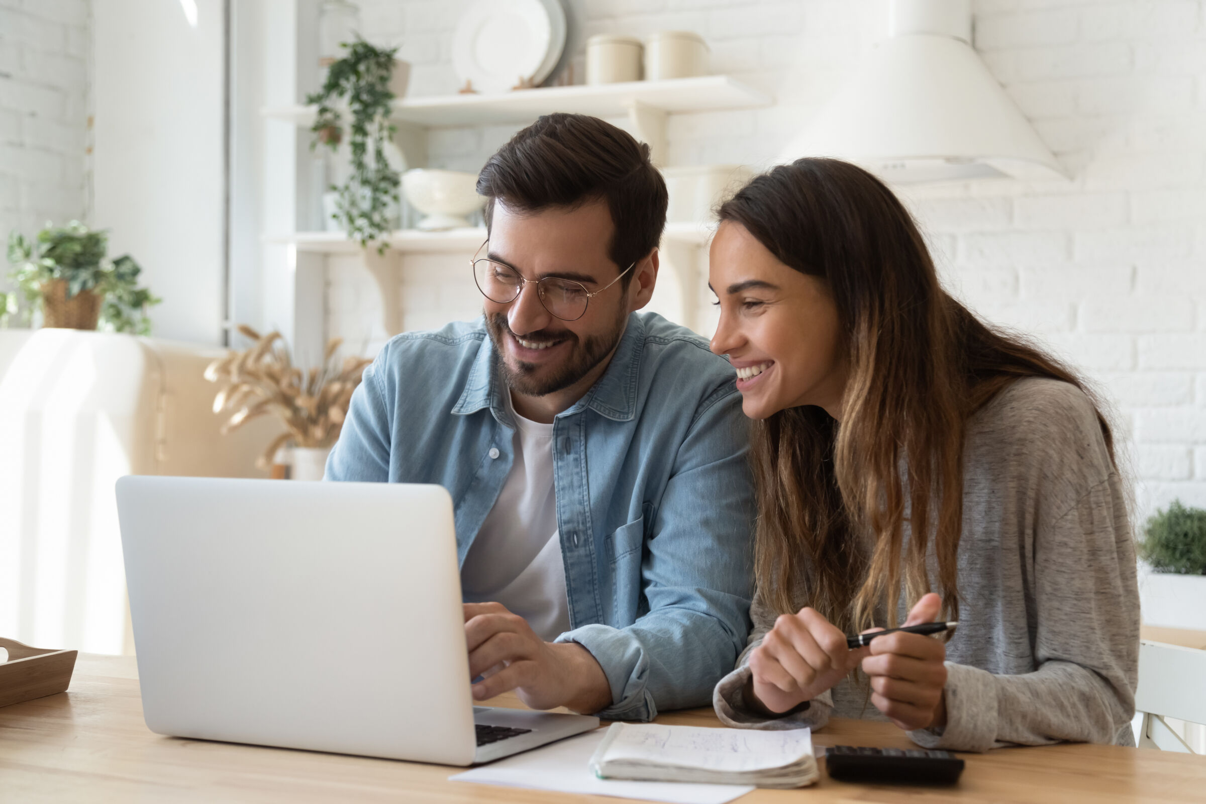 Couple smiling at a laptop
