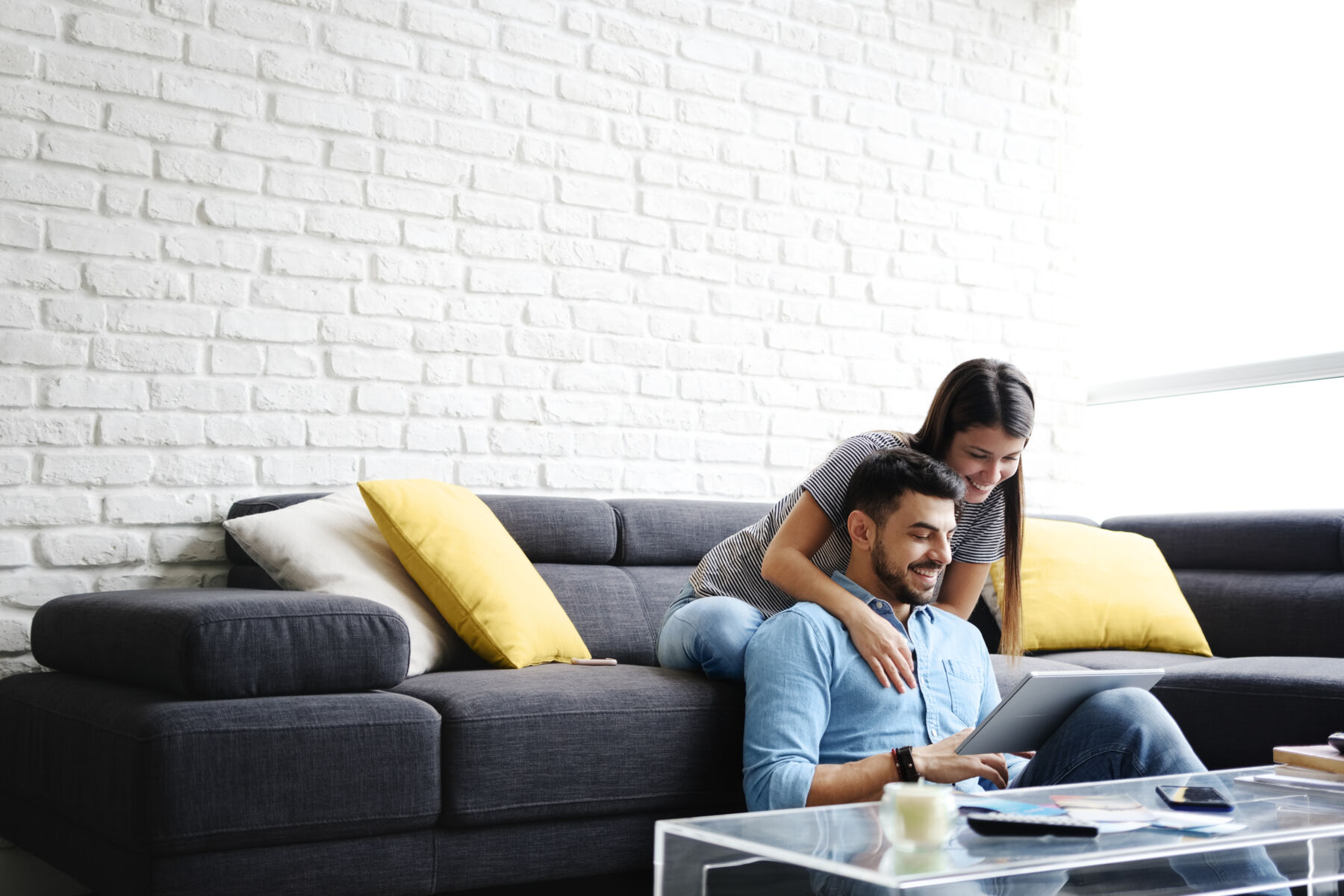 Couple cuddling in front of laptop