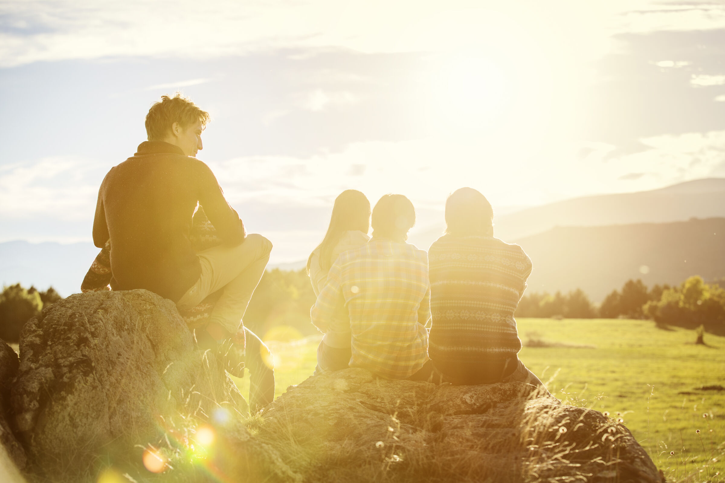 Group of people sitting and watching the sunset