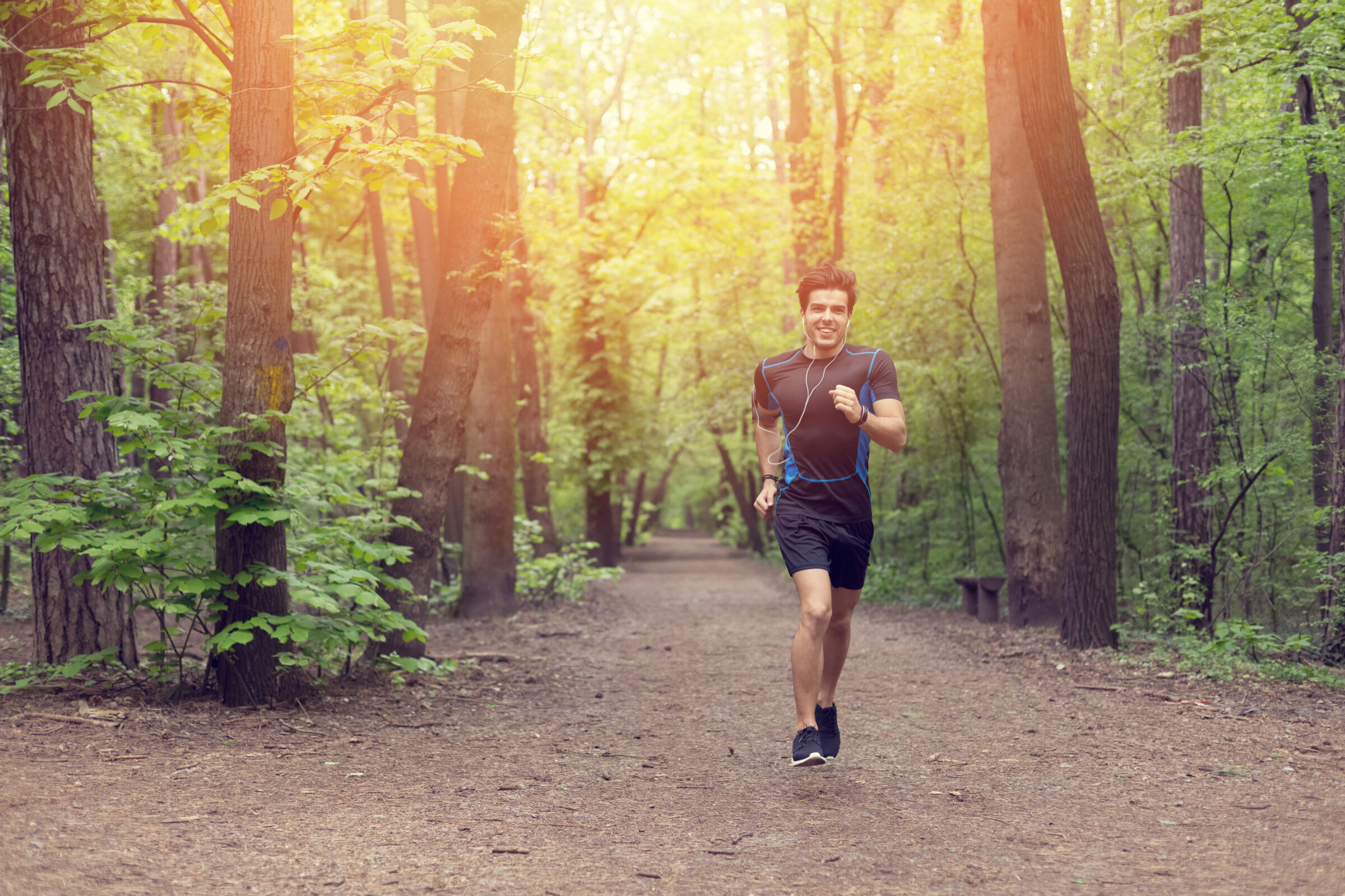 Man running on a forest trail