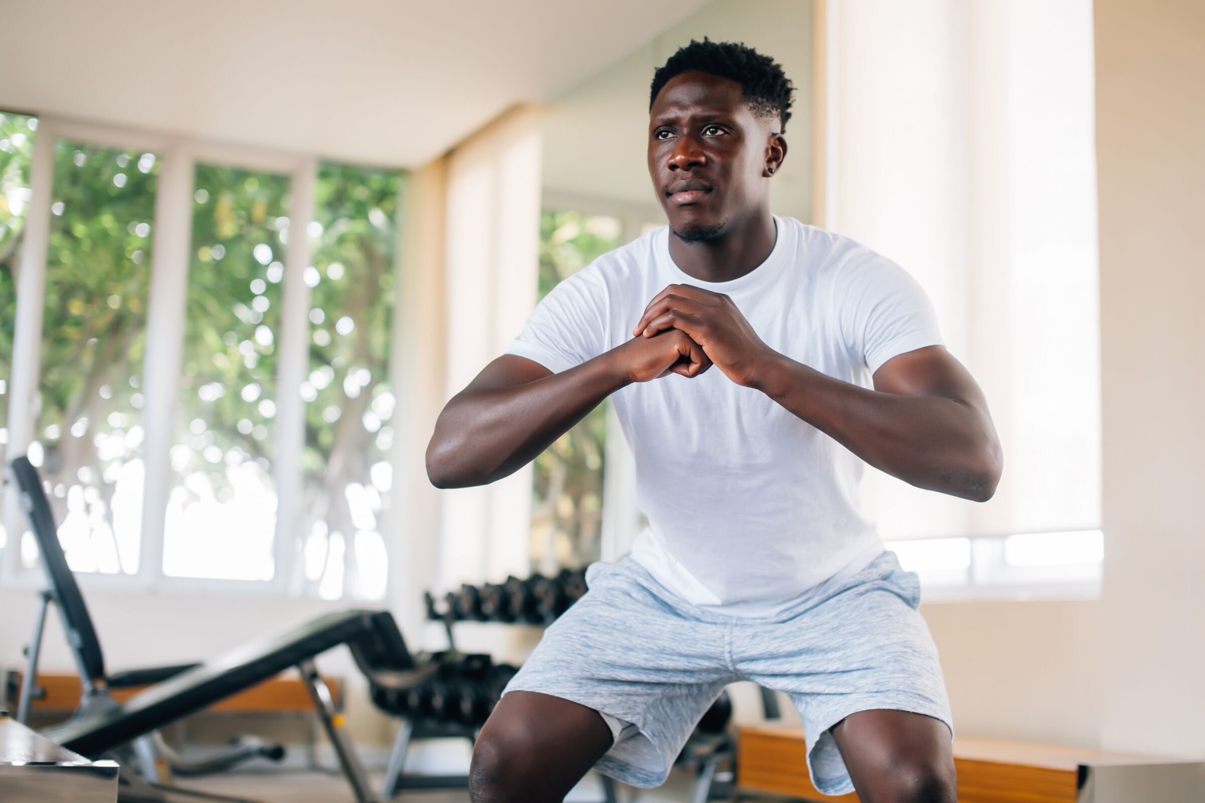 Man doing squats in a gym
