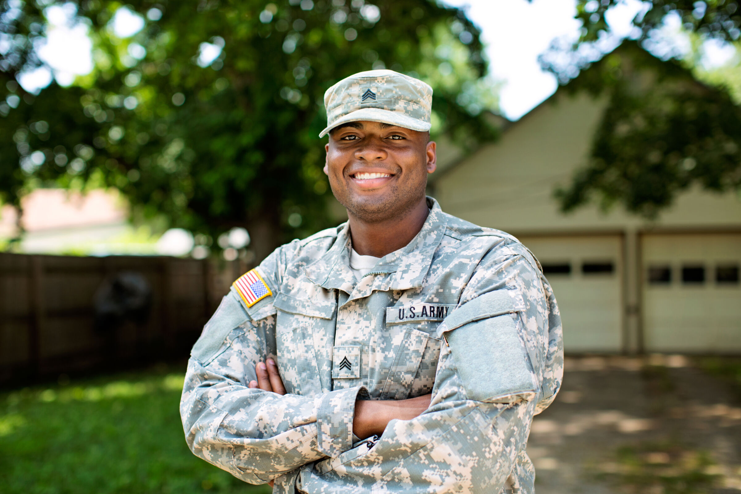 Veteran smiling in front of home