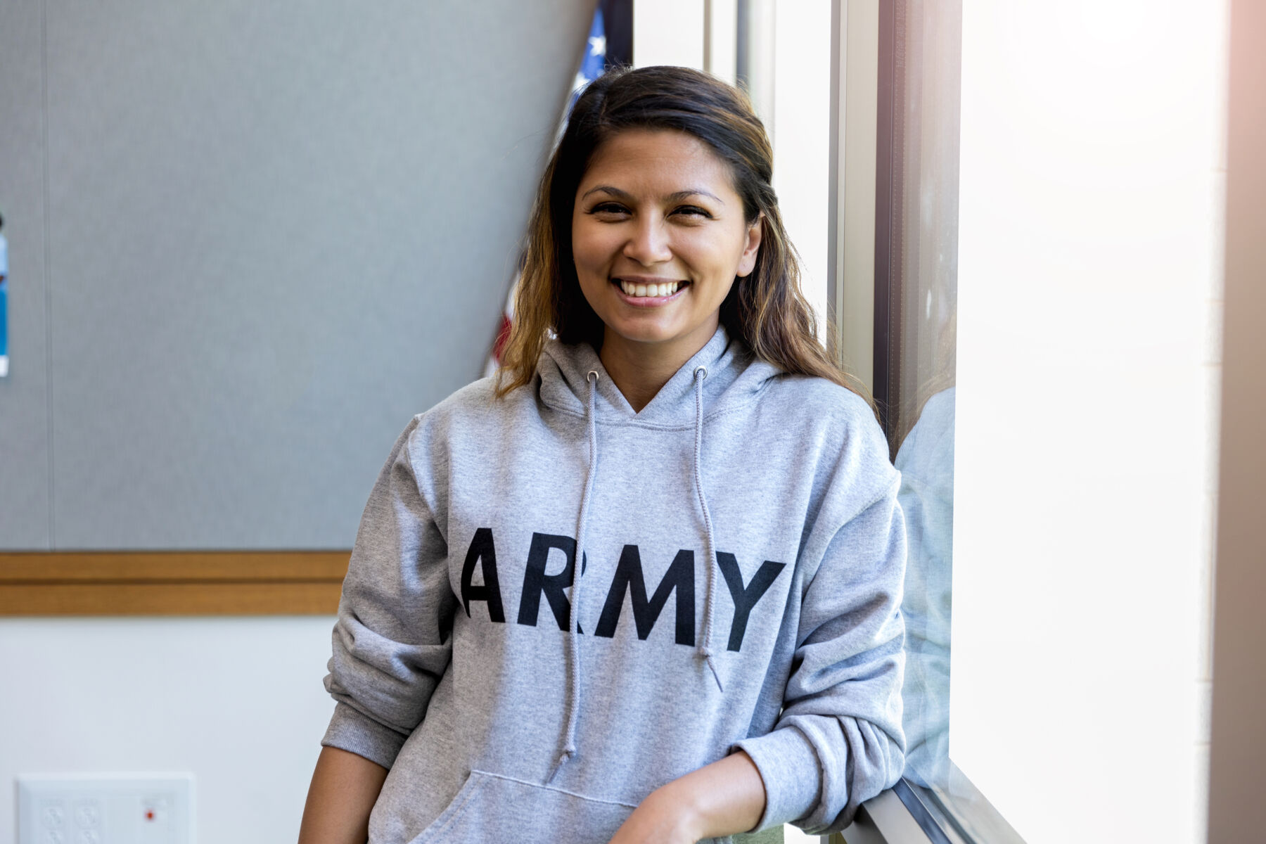 Woman in army sweatshirt smiling
