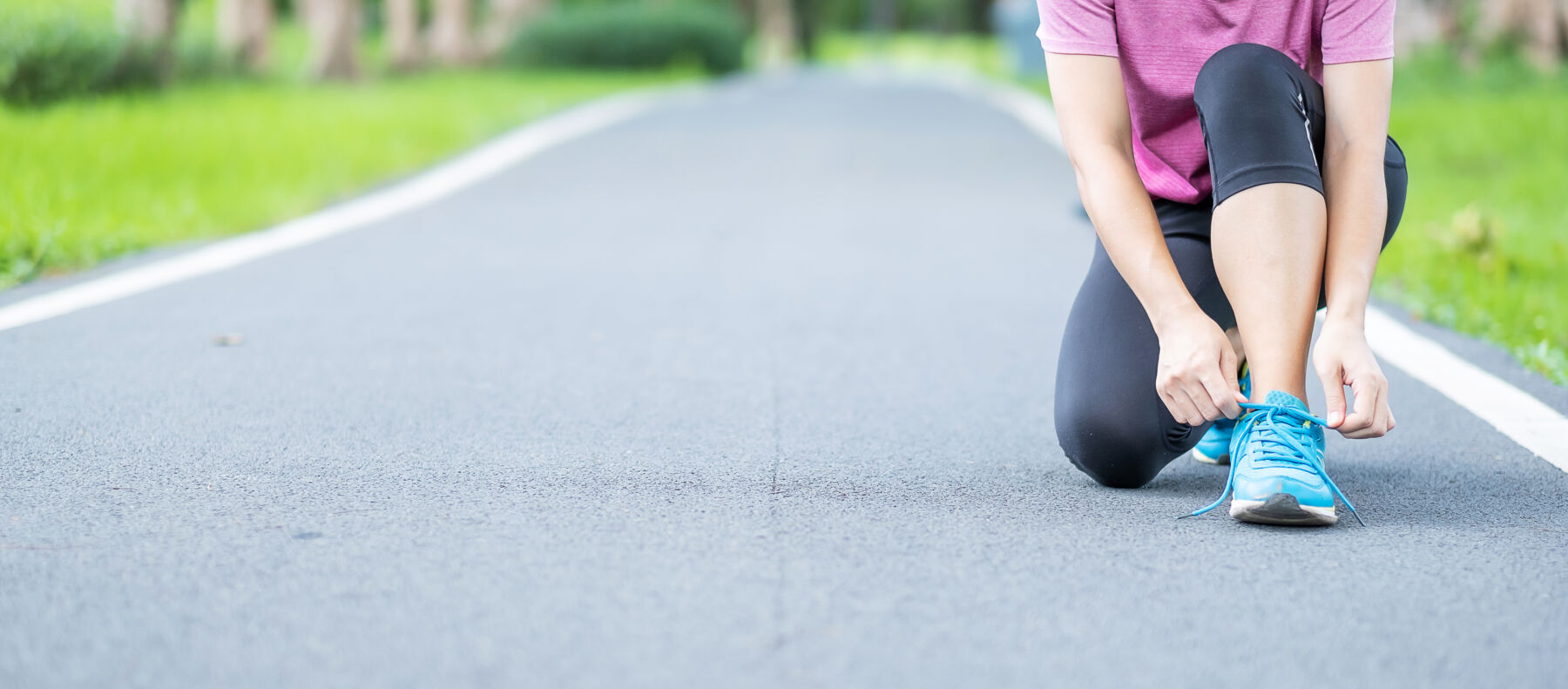 Runner ties her shoes