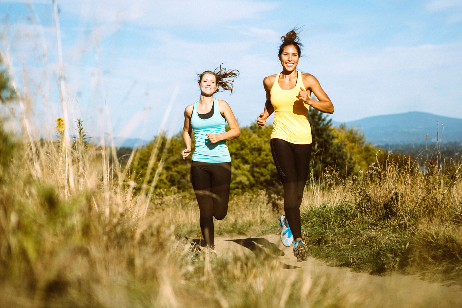 Two women jogging on a trail
