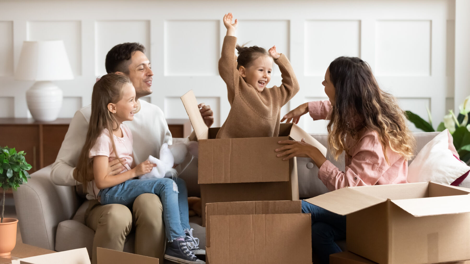 Family playing with moving boxes
