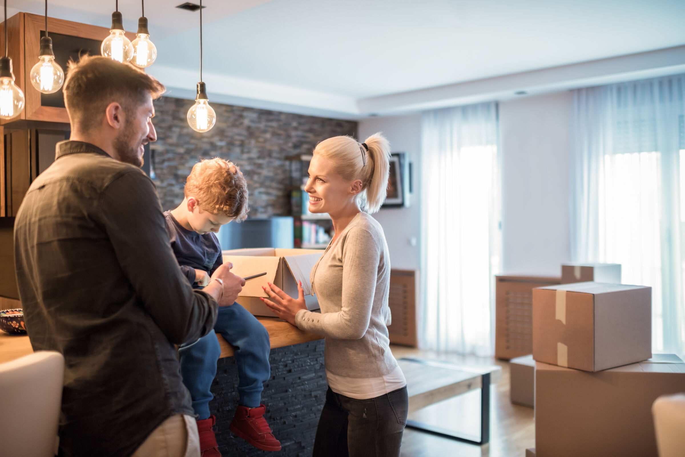 Family in the kitchen with moving boxes