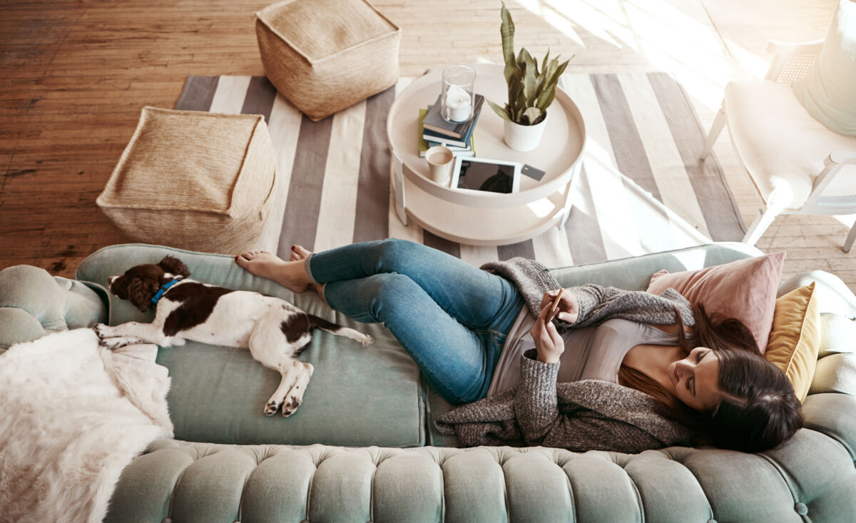 Woman relaxing with a dog on the couch