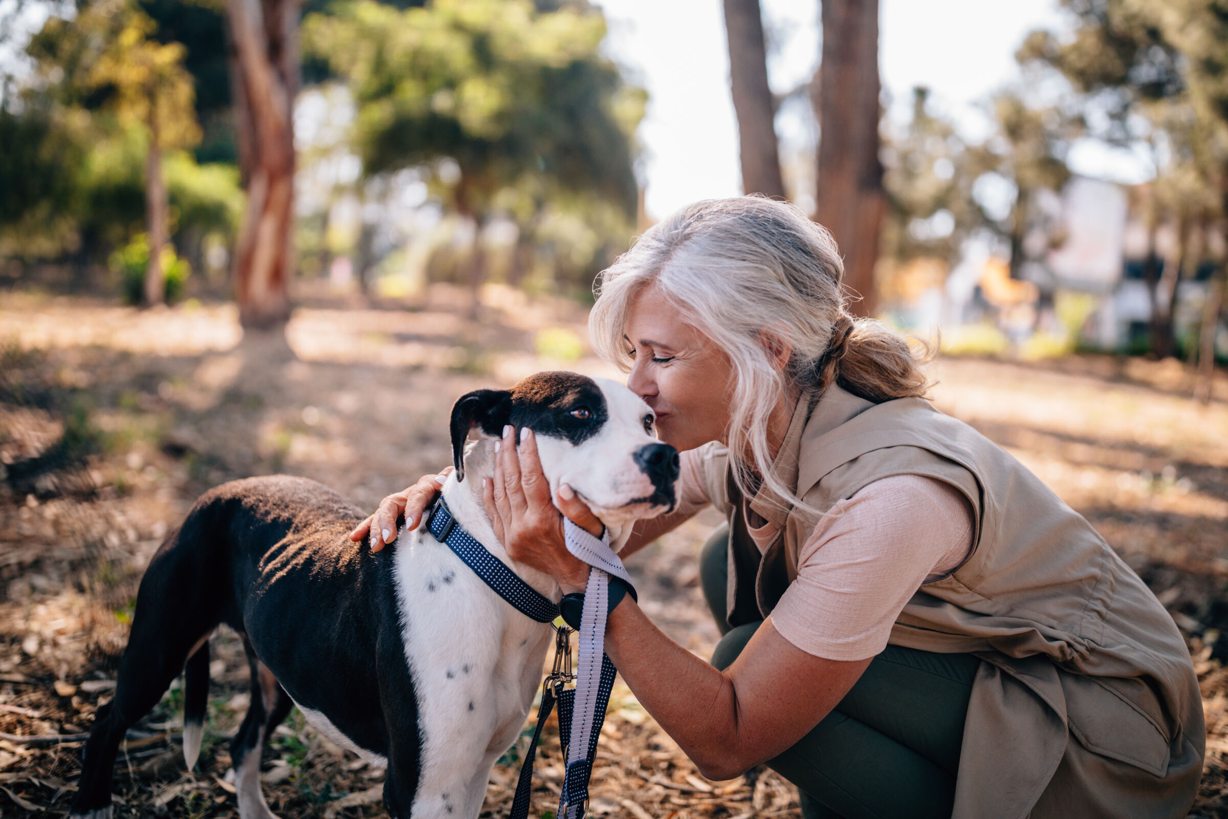 Woman kissing her dog