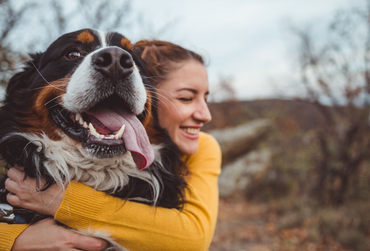 Woman cuddling her dog