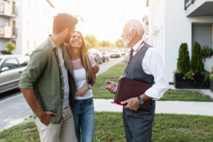 Couple and real estate agent talking