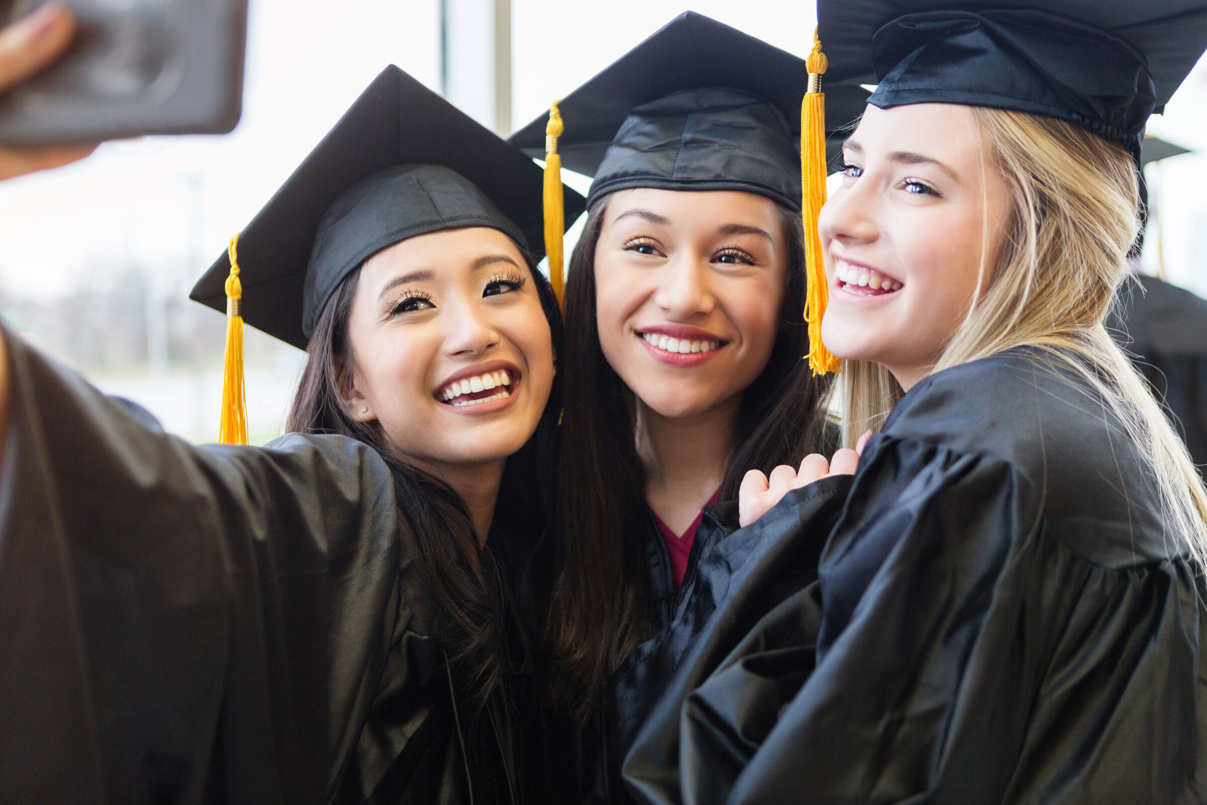 Group of friends taking a selfie at graduation