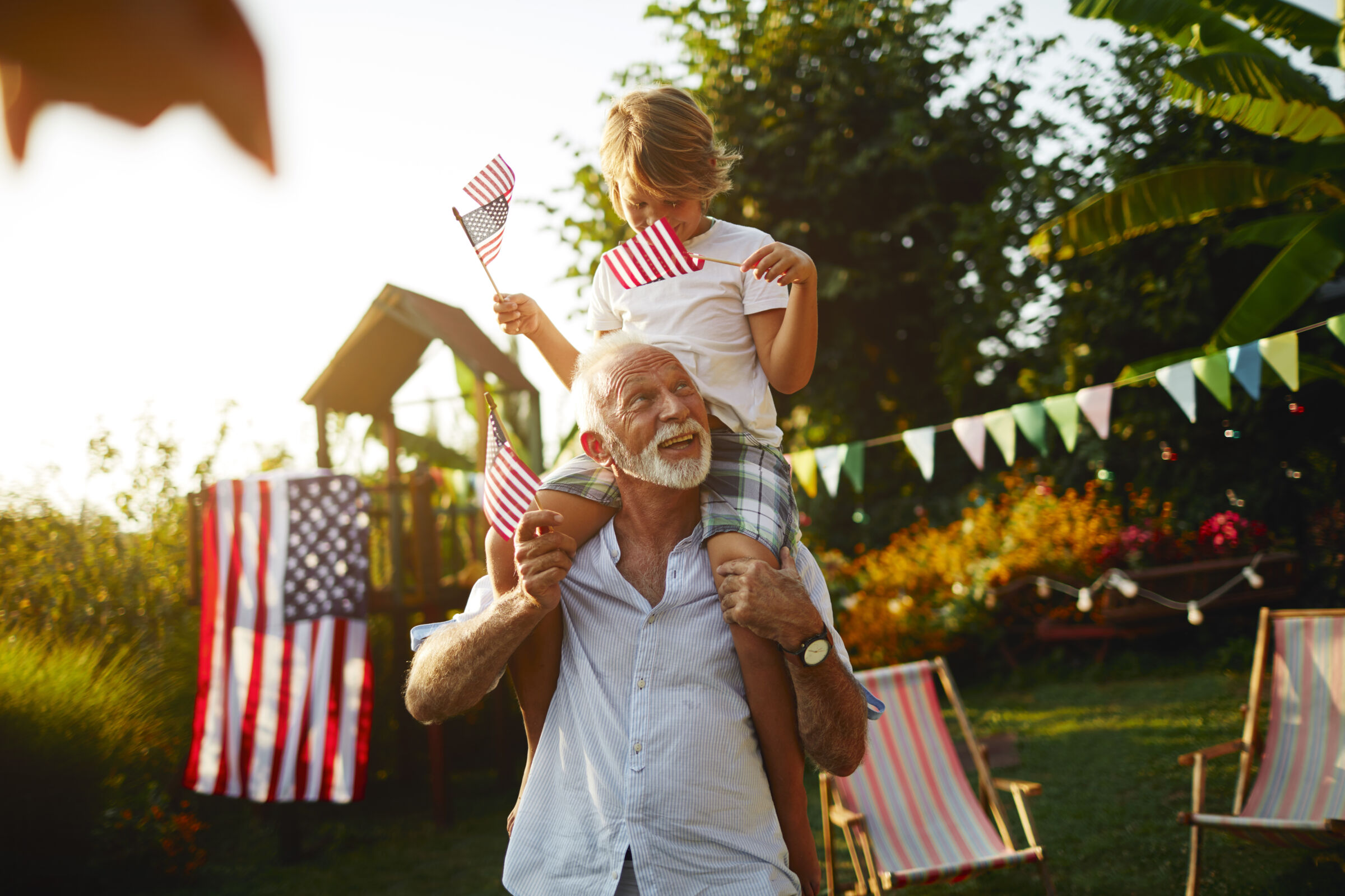 Grandfather and grandson celebrating 4th of July