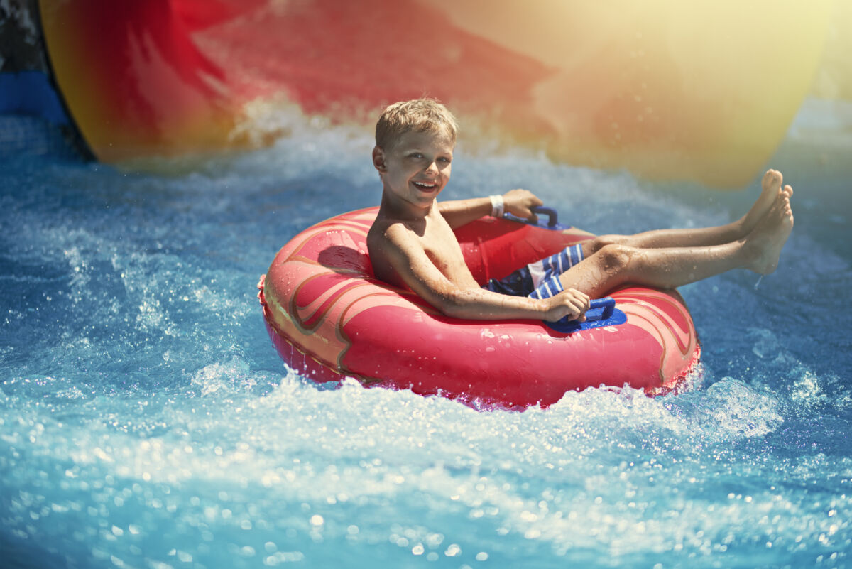 boy in waterslide tube at water park