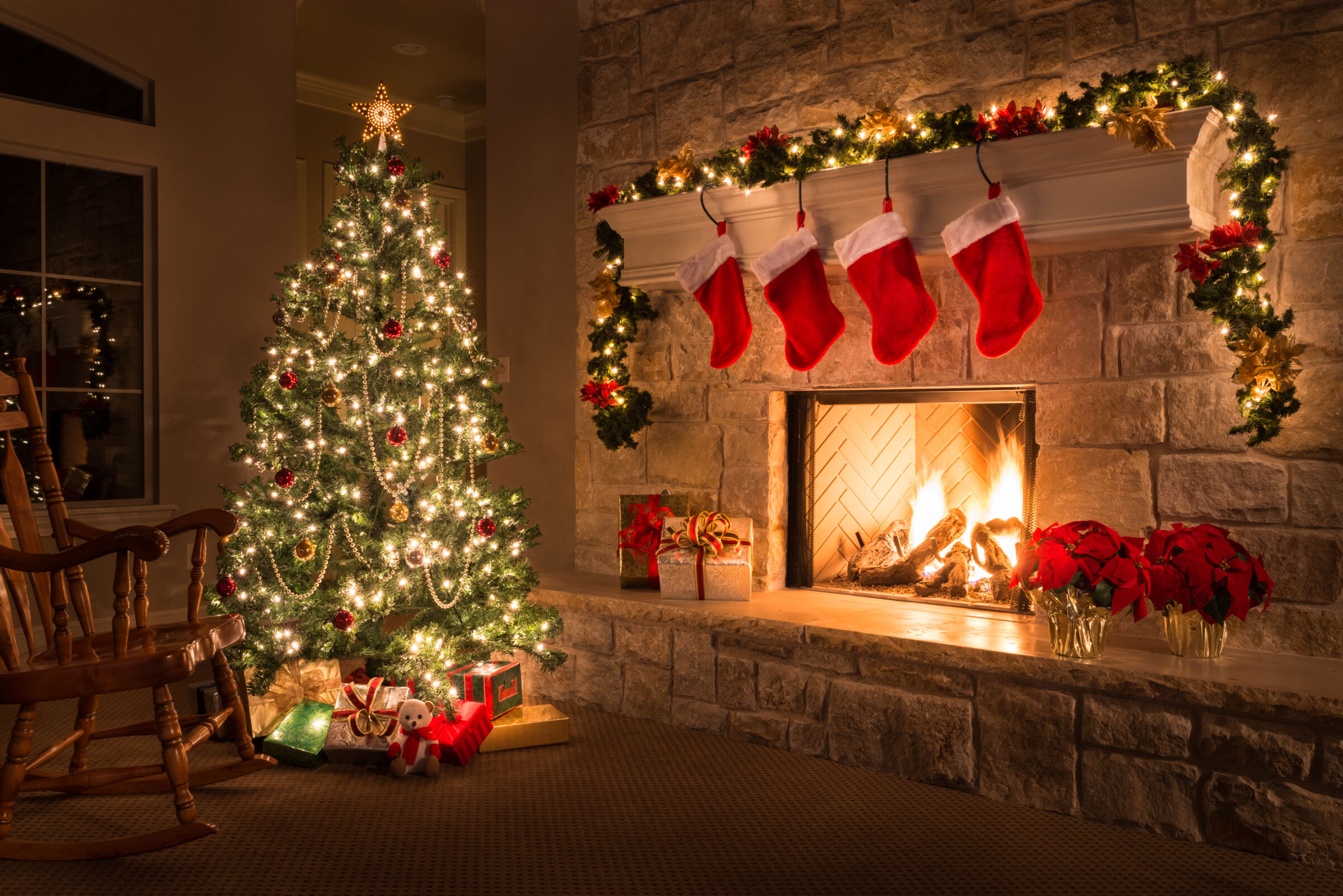 Christmas tree by fireplace at night