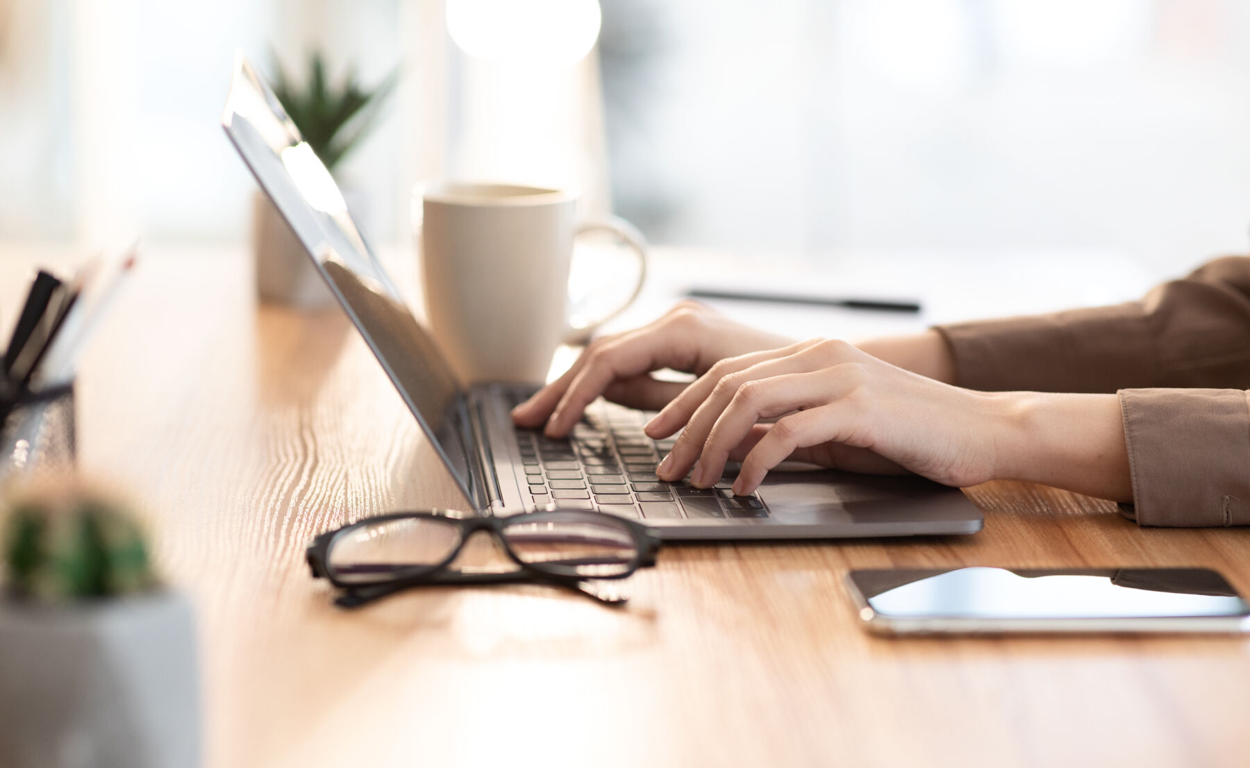 pair of hands typing on computer
