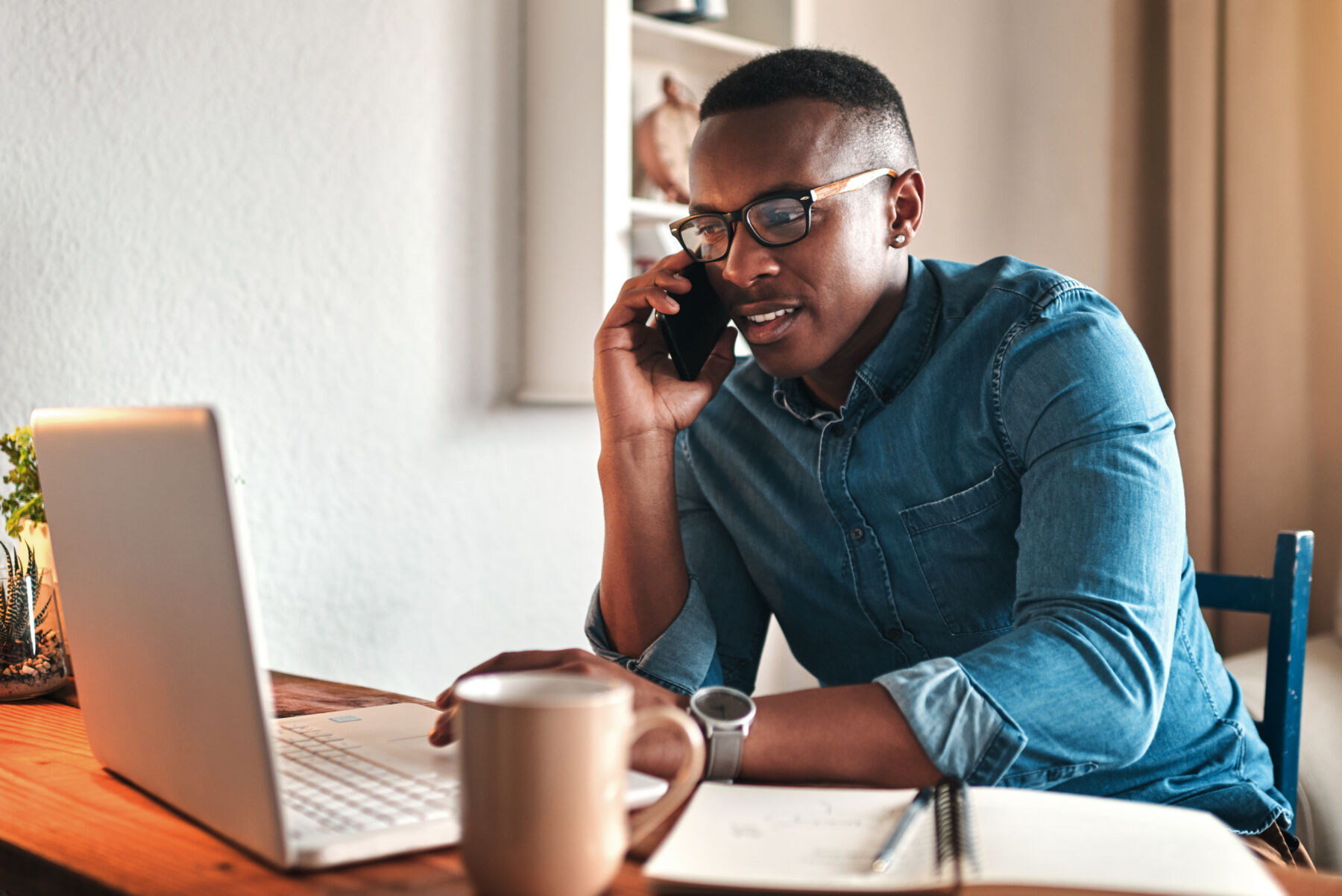 man working from home on phone and computer