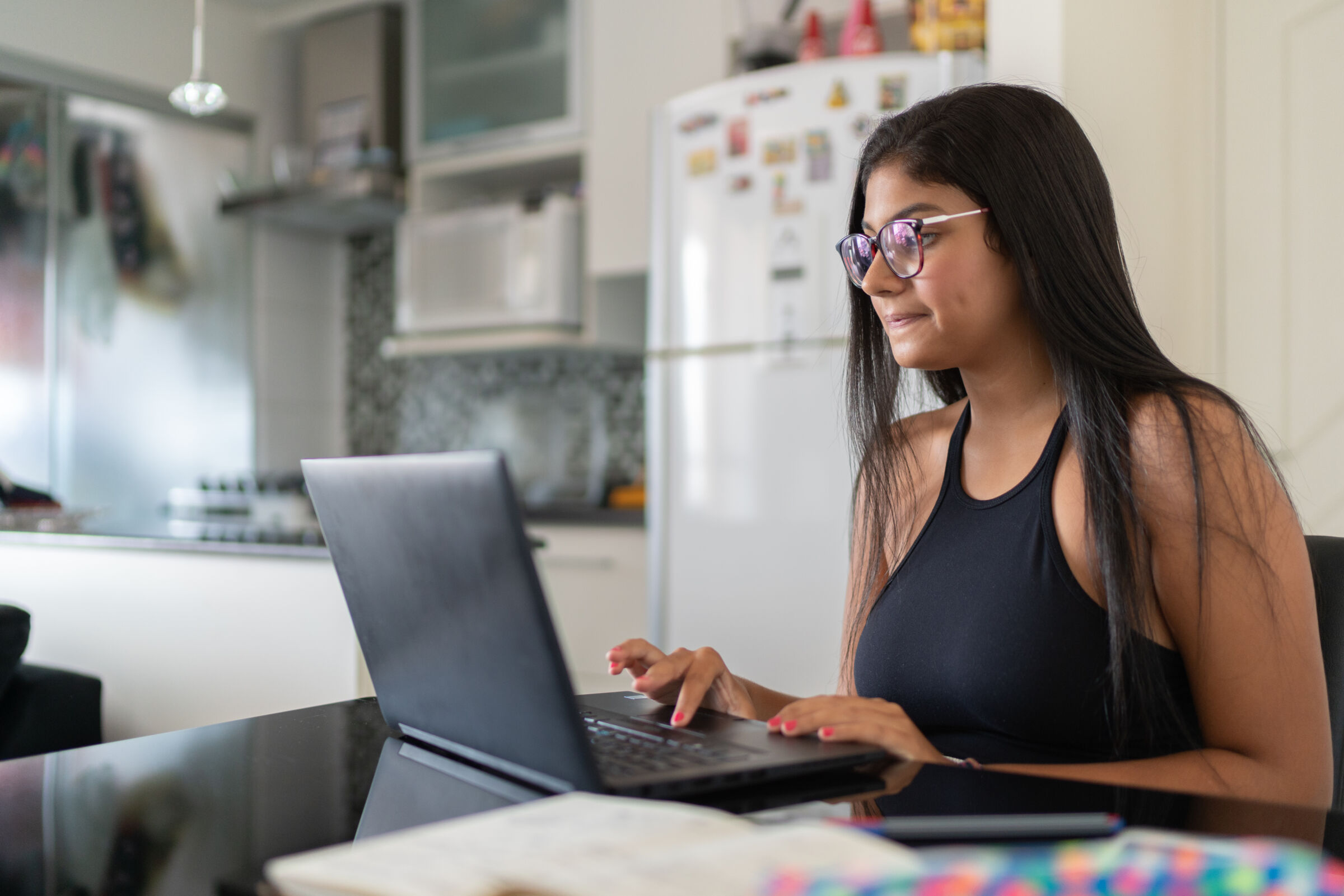 teen studying at kitchen table