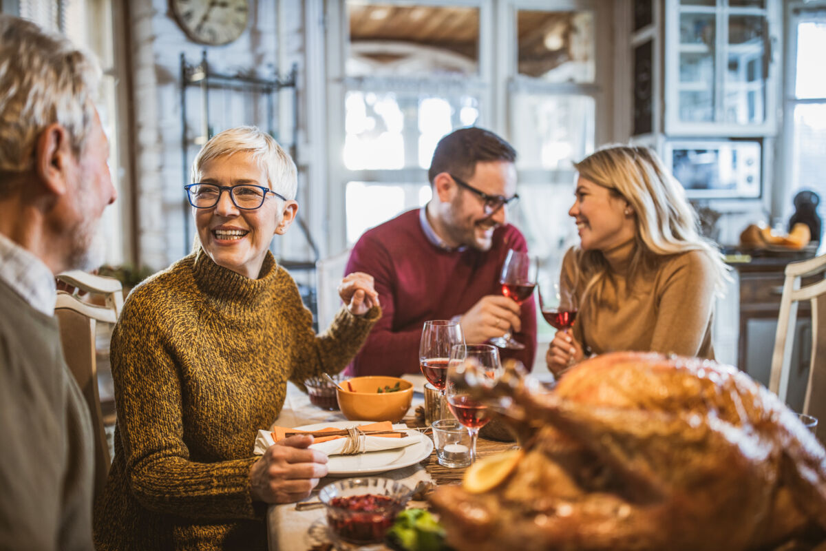 Happy family eating Thanksgiving dinner
