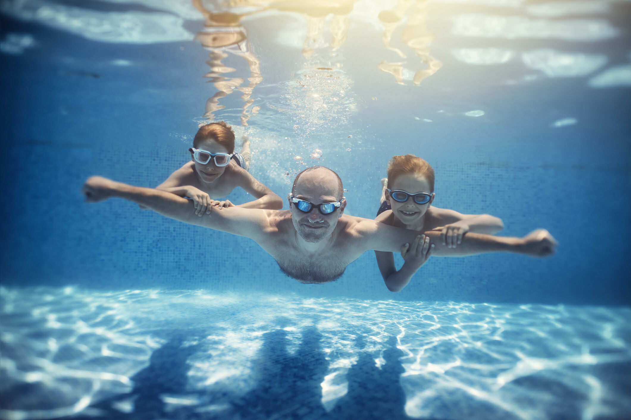 Dad and kids swimming