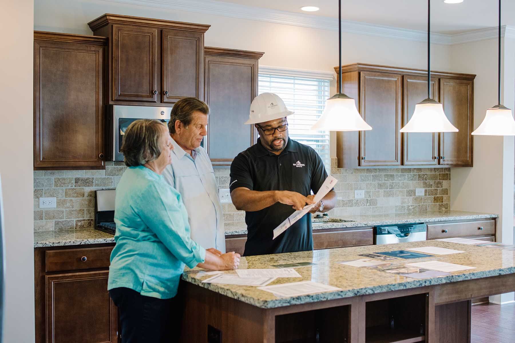 Couple With Construction Manager During New Home Orientation