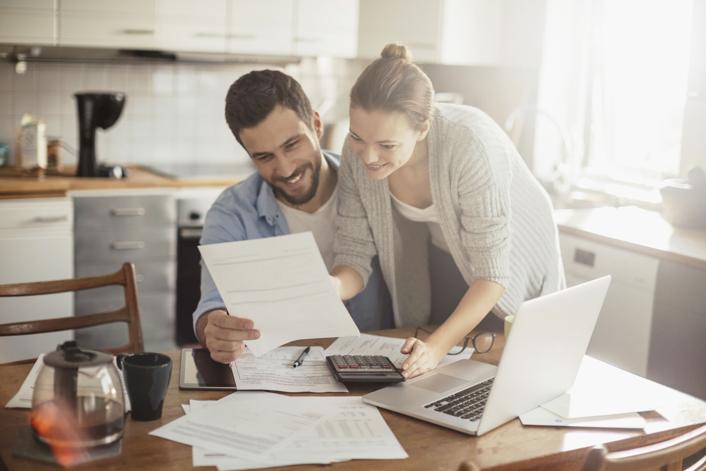 Couple reviewing paperwork in kitchen