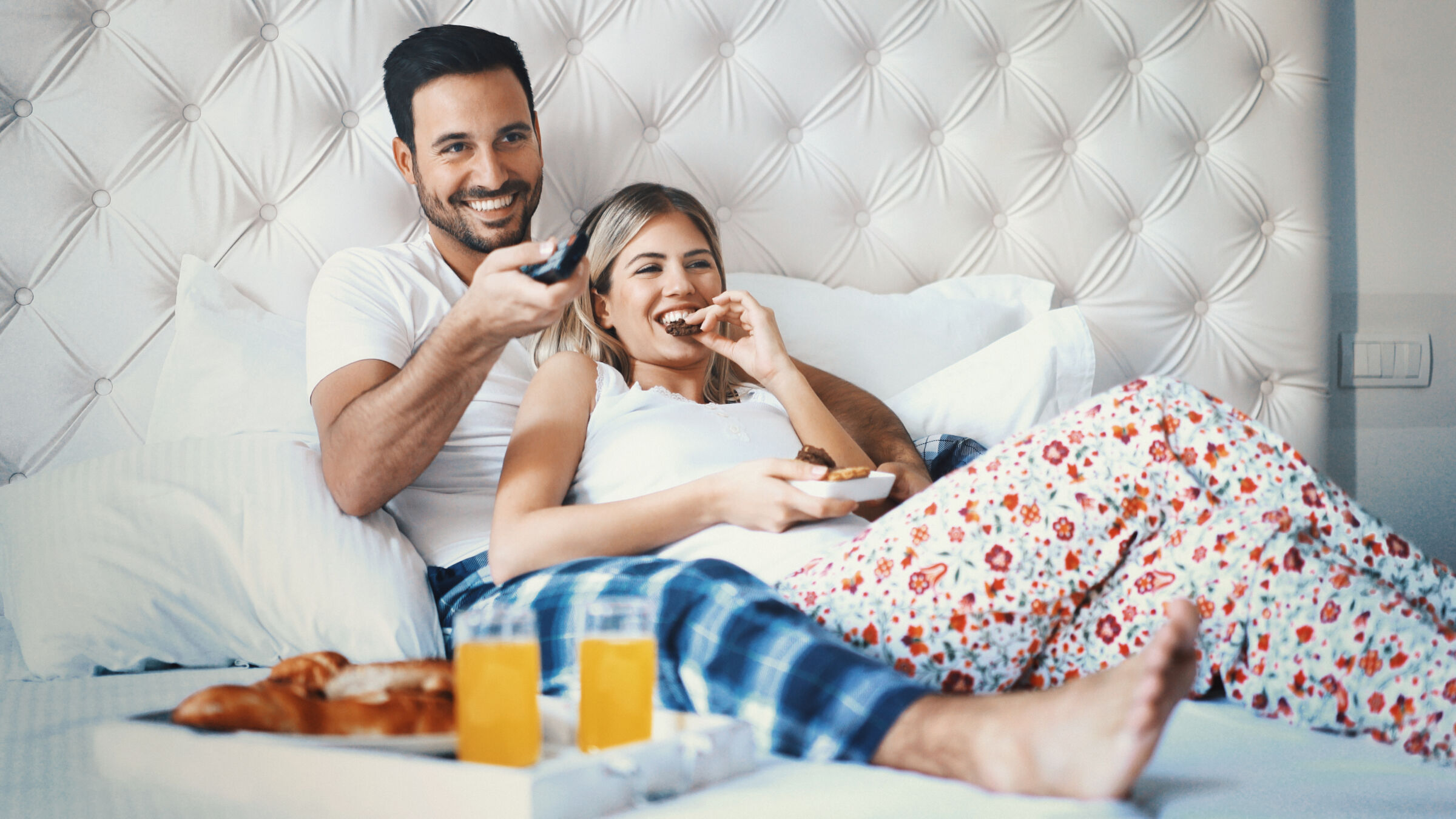 Couple eating breaking in bed