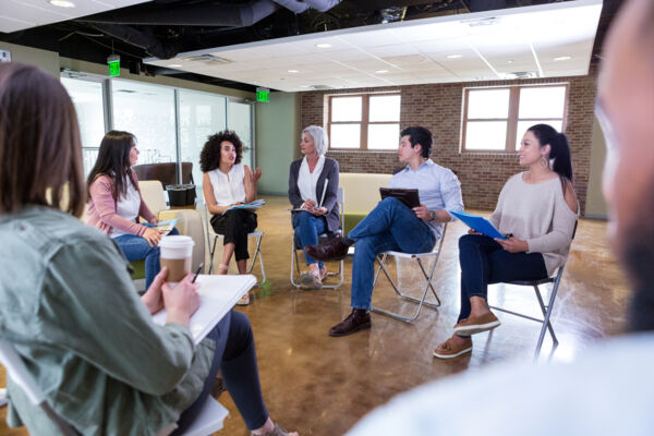 People Having Meeting and Talking in Circle of Chairs