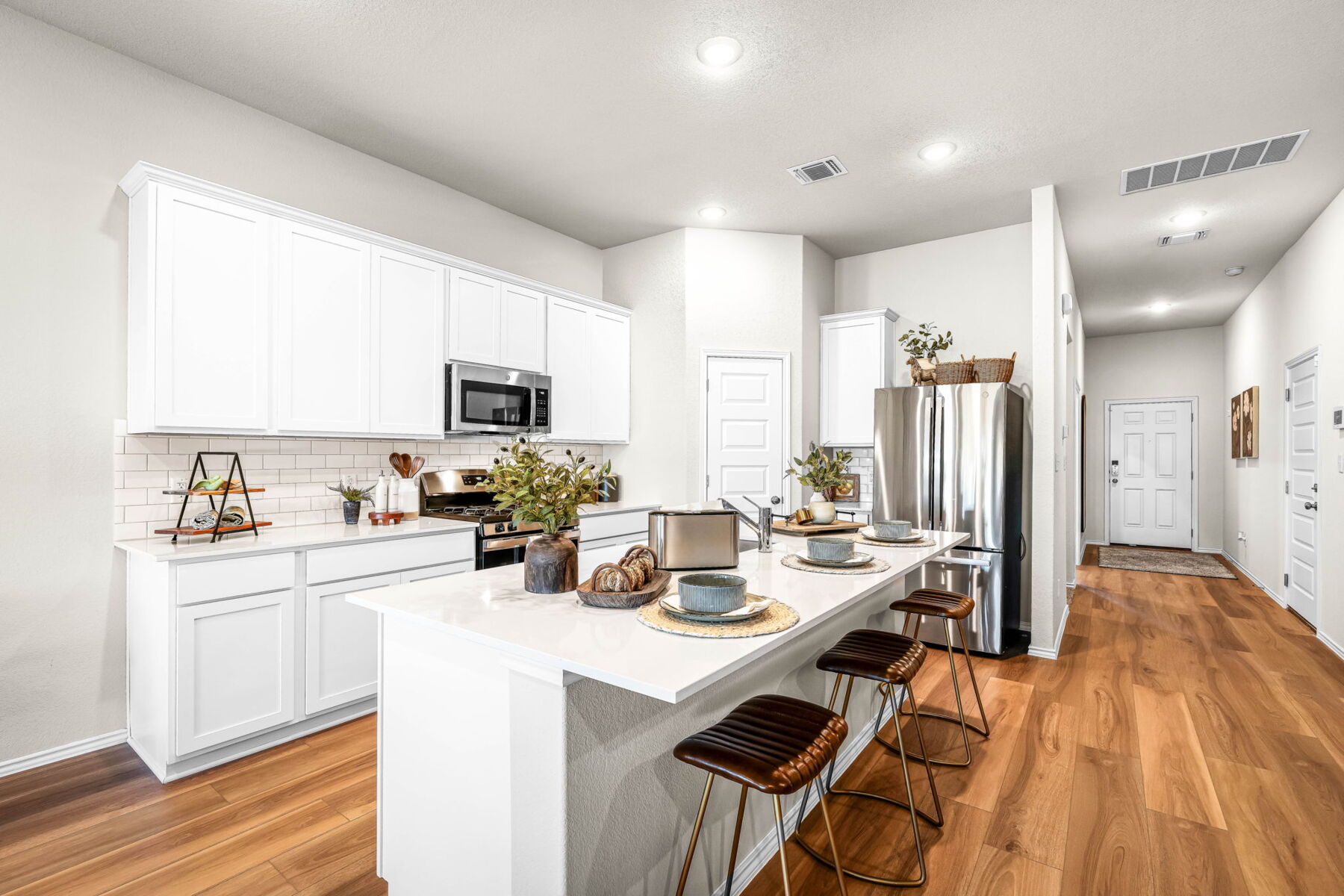 This is kitchen of the Hawkins plan and is the model home in Carillon at 13305 Eppright Trace Blvd., Manor, TX.,