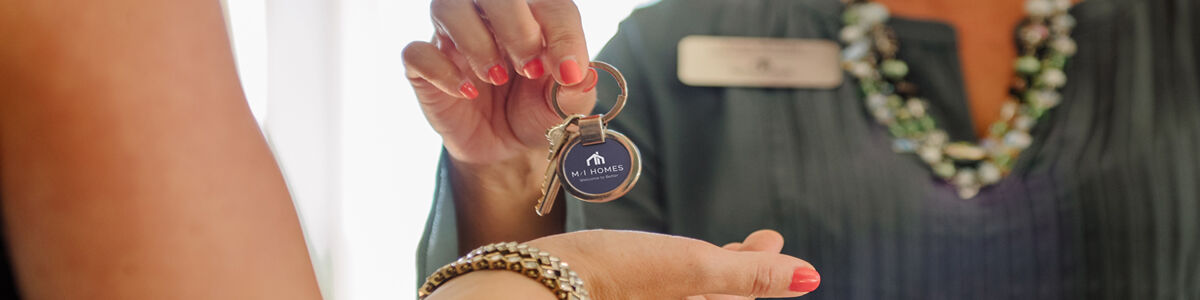 Real Estate Agent Handing Client Keys to House