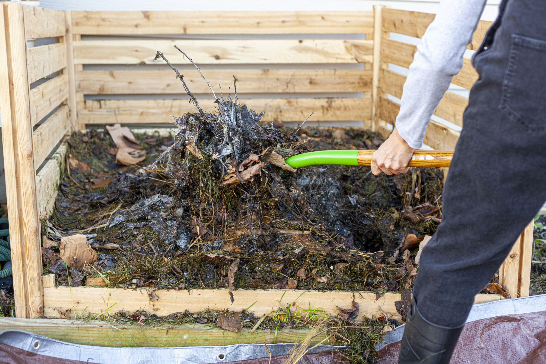 Person Shoveling Into Compost Bin