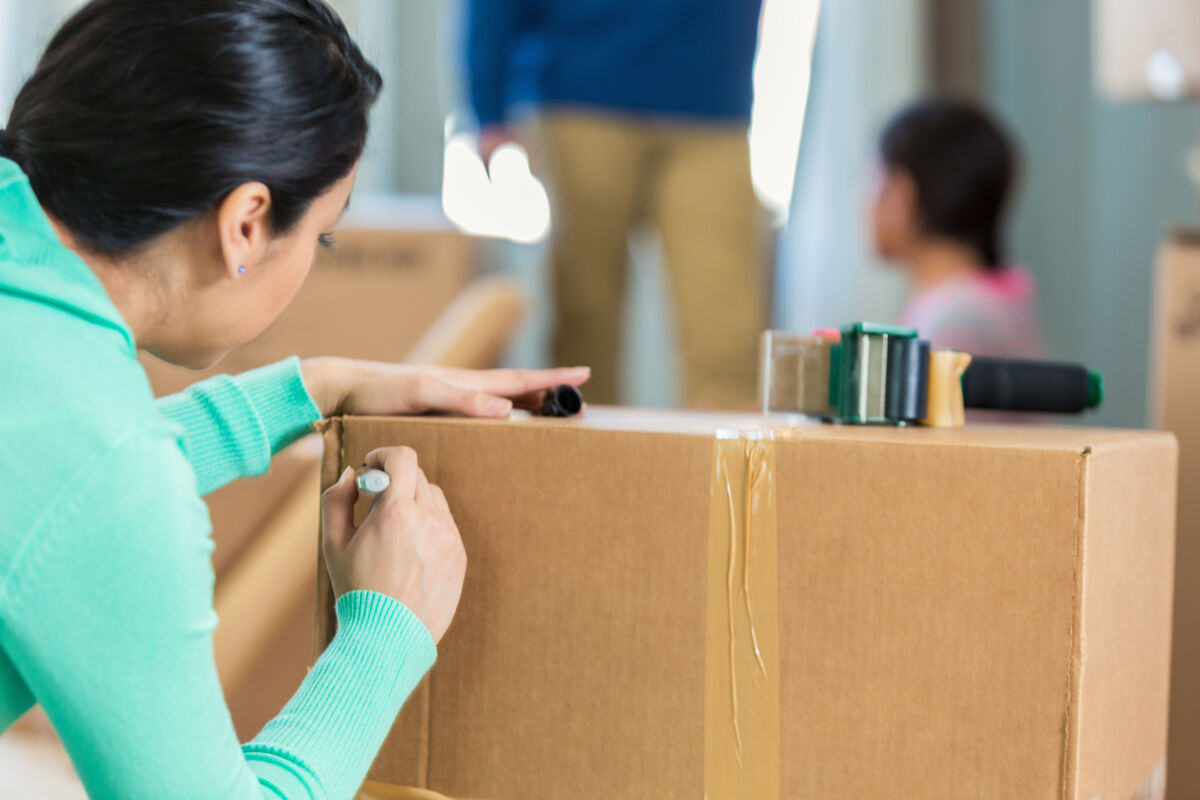 Woman Labeling Moving Boxes